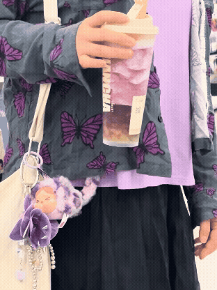 A gif of me with a grape drink and purple trinkets